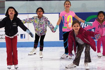 Children practicing ice skating