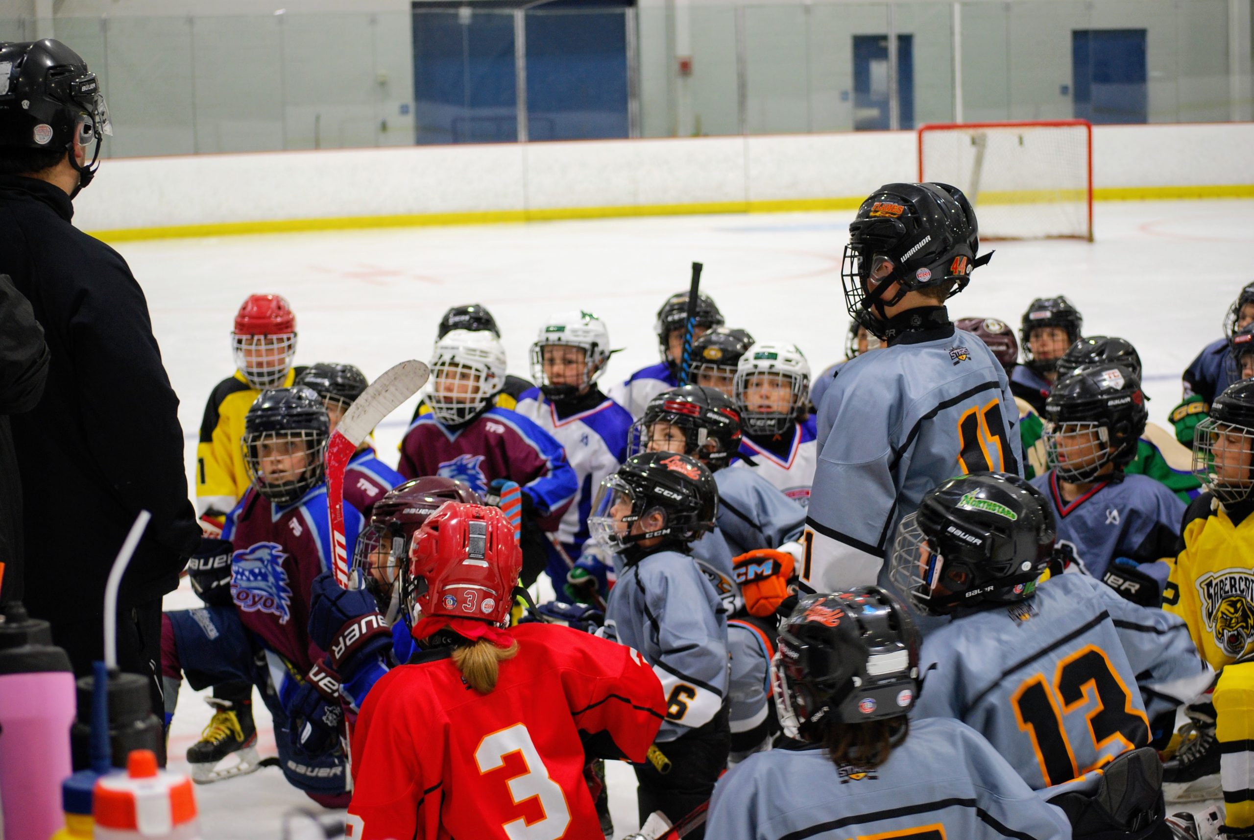 Hockey team huddled up listening to coach