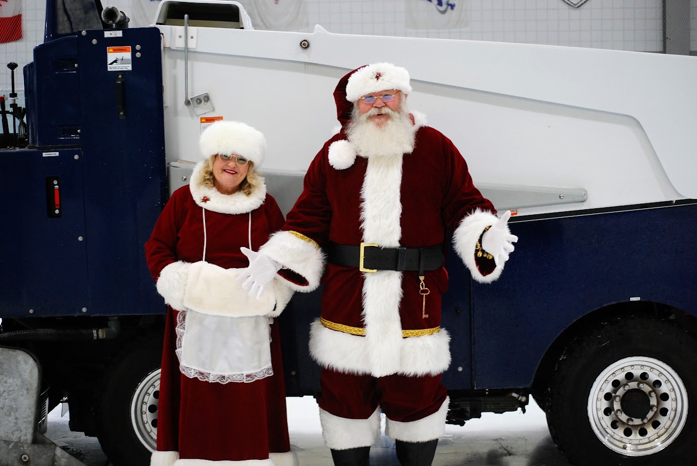 Santa and Mrs. Clause in front of Zamboni.