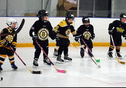 Children learning to play hockey