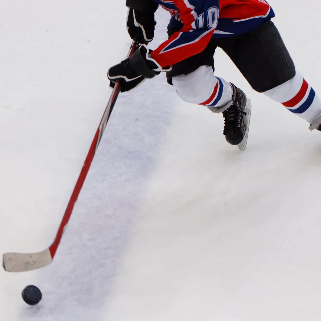 Hockey player stick handling a puck